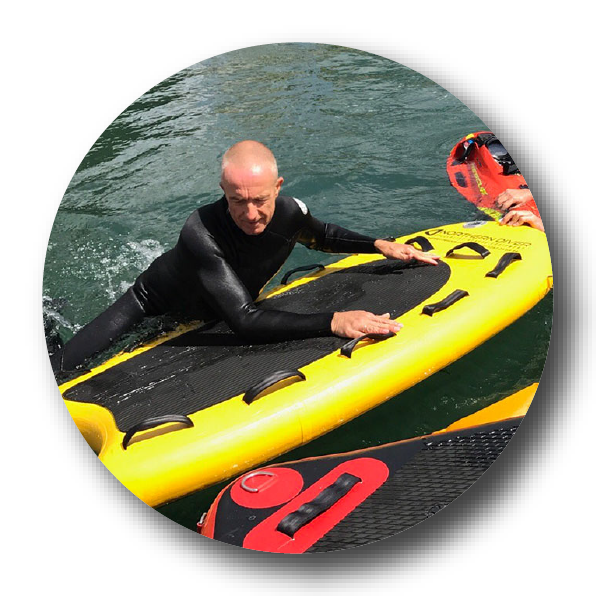 Snorkelling man lifts himself onto an inflatable board